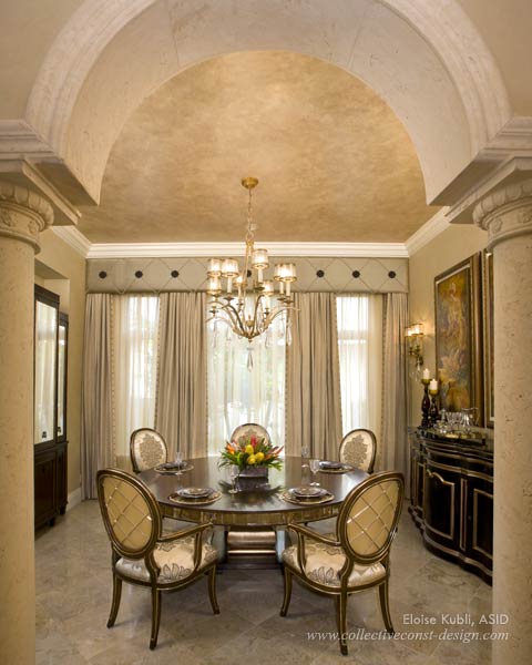 Elegant gold-leaf and antiqued mirror detailing exude luxury in the formal dining room.
