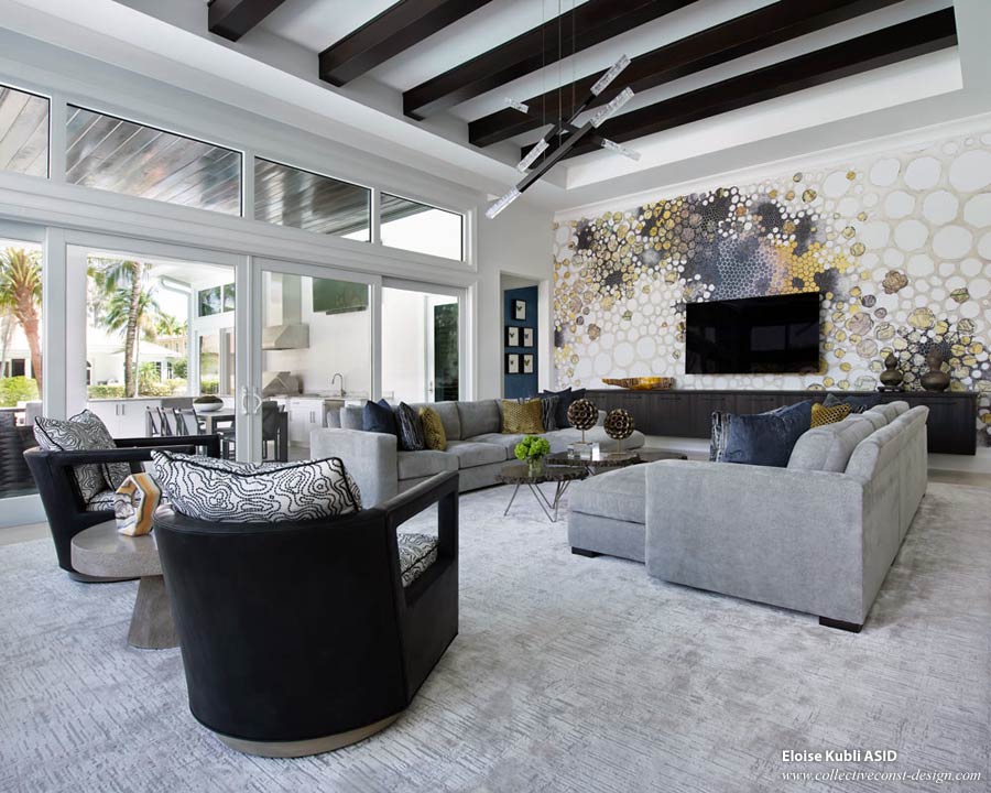 A contemporary upscale family room in Florida, featuring a custom sectional, custom lighting, and an original mural.