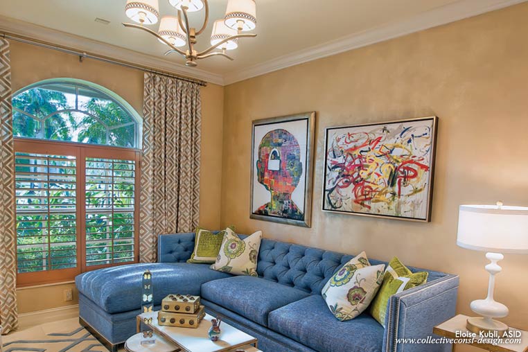The centerpiece of the space is a custom sofa with a chaise. Under the stylish frame, it holds a queen sleeper. The walls have a shimmer, a gorgeous lusterstone finish, setting off an original mixed media painting by Brian Poli-Dixon called “Unlocked.”