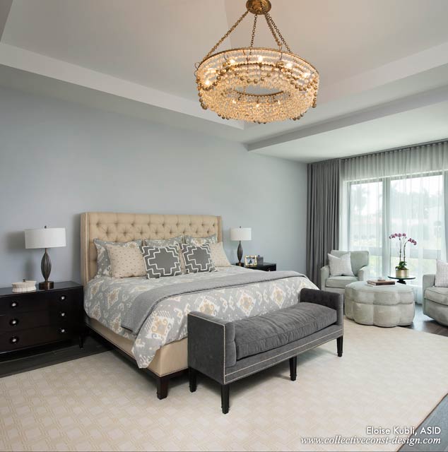 A beaded crystal chandelier is a focal point in the master bedroom.