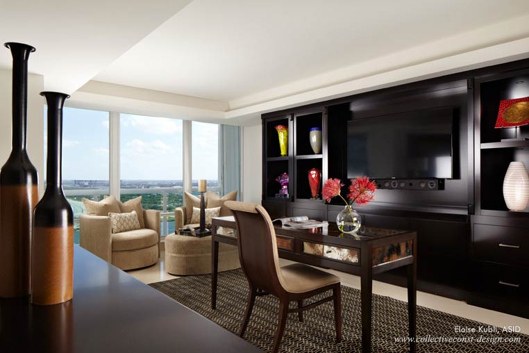 Behind the TV in this office, a custom wall unit contains a zoom bed for guests. Swiveling armchairs allow occupants and guests to enjoy the magnificent view.